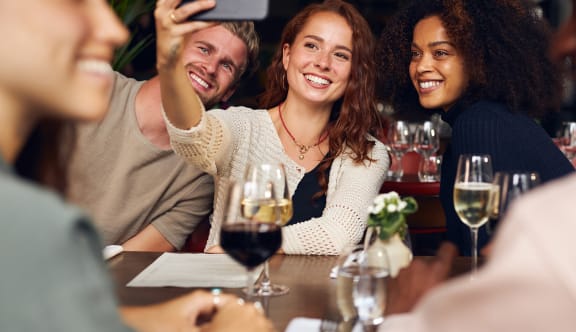 a group of people sitting at a table in a restaurant