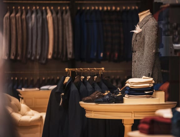 a display of clothes and shoes in a clothing store
