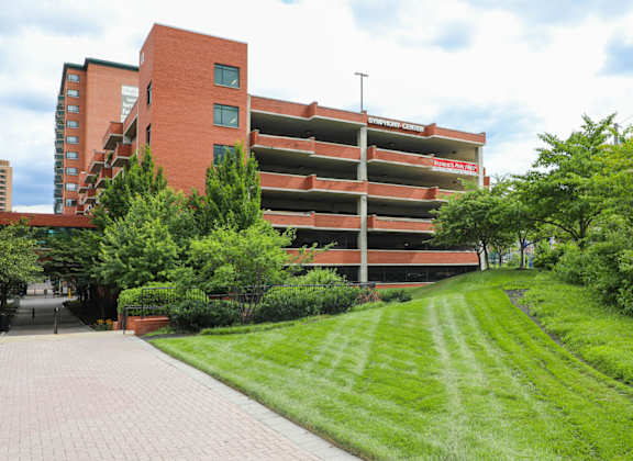 a red brick building with a lawn in front of it at Symphony Center Apartments, Baltimore, MD, 21201