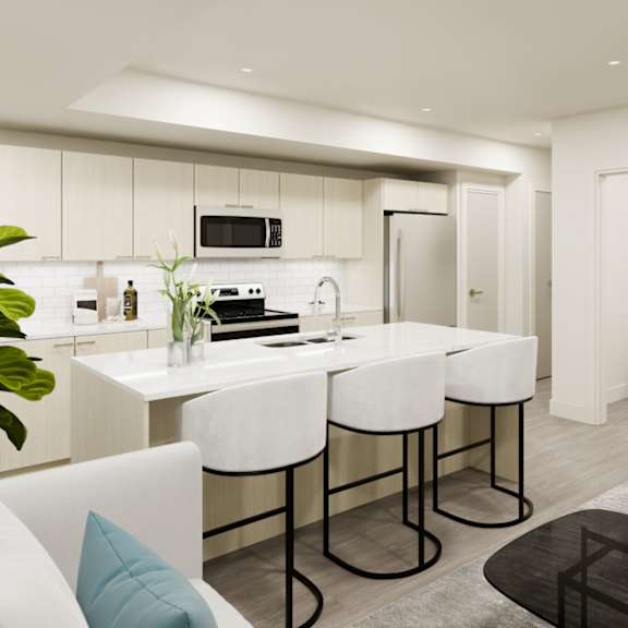 A modern kitchen with white chairs and a black countertop.