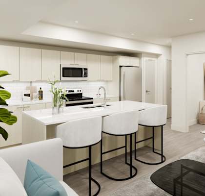 A modern kitchen with white chairs and a black countertop.