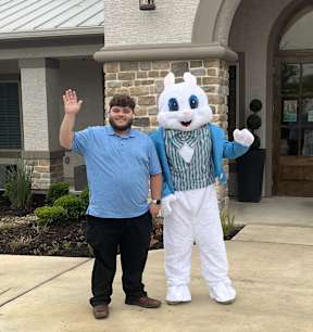 a man in a costume of the easter bunny standing next to a man dressed