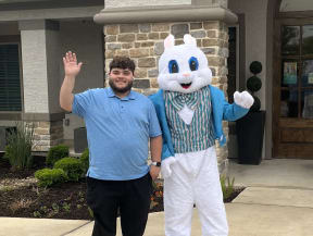 a man in a costume of the easter bunny standing next to a man dressed