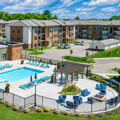 A large building with a pool in front of it.