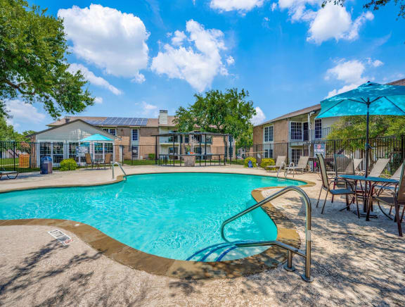 our apartments have a resort style pool with chairs and umbrellas  at Creek on Calloway, Richland Hills, 76118