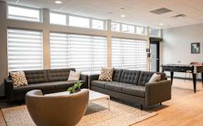 A living room with two couches and a table.