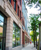 a sidewalk in front of a building on a city street