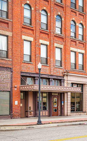 A red brick building with a black lamp post in front at 206 Flats, Spokane