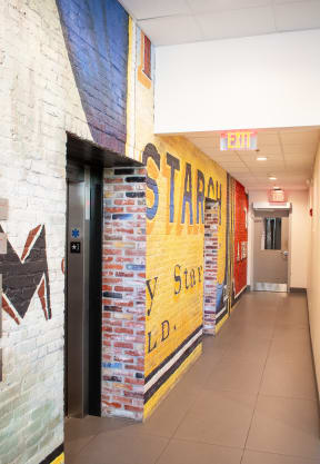 a mural on the wall of a hallway in a building