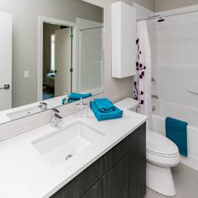 A white sink with a blue towel on it.