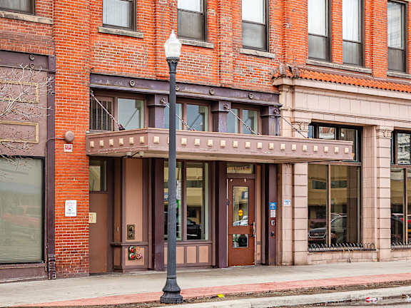 A red brick building with a black lamp post in front  at 206 Flats, Washington, 99201