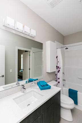A white sink with a blue towel on it.