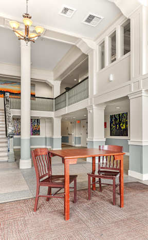 A dining table with two chairs in a room with a staircase at 206 Flats, Spokane