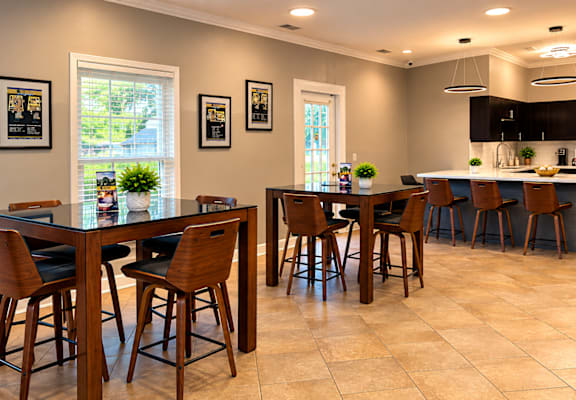 A kitchen with a table and chairs in the middle of the room.