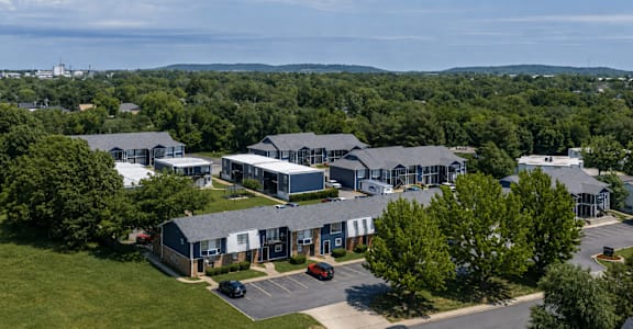 A large building complex with a parking lot in front.
