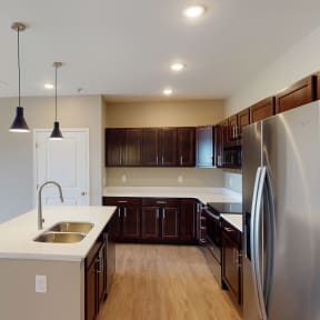 a kitchen with stainless steel appliances and a white counter top