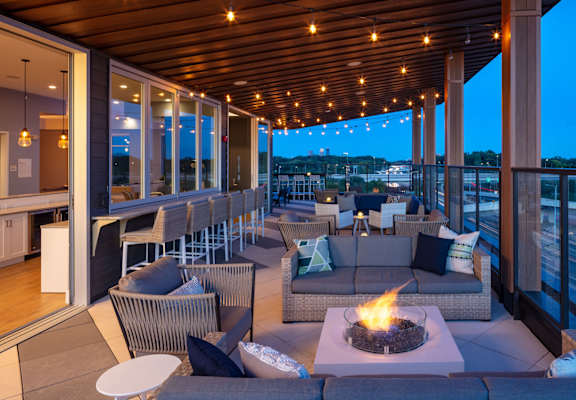 A patio with a fire pit and seating area.