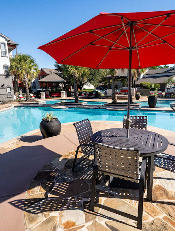an umbrella by a pool at Retreat at Steeplechase in Houston, TX