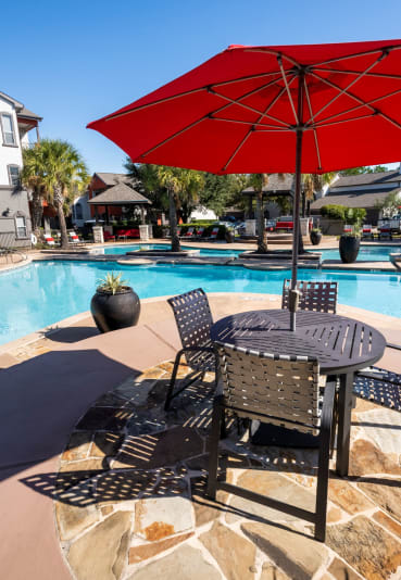 Swimming Pool Area With Shaded Chairs at The Retreat at Steeplechase, Houston