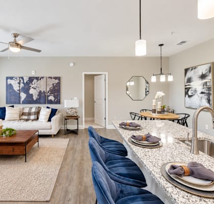 A modern kitchen and living room with a dining area.