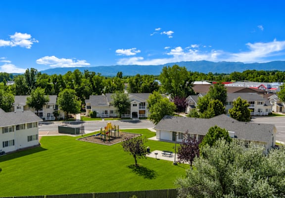 A large white building with a green lawn in front of it.