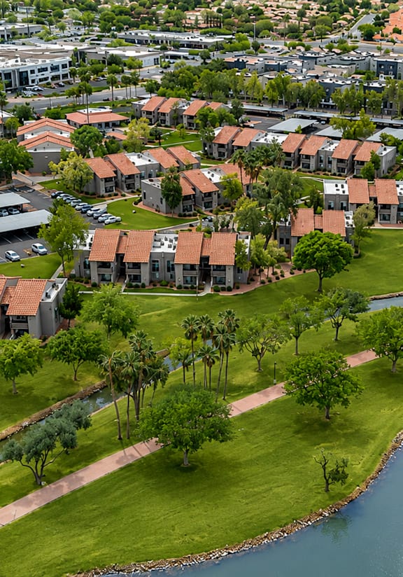 A bird's eye view of a residential area with a river running through it.