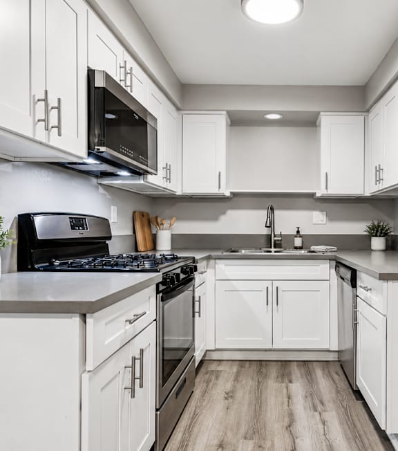 A well-lit, modern kitchen and living room with a dining area.
