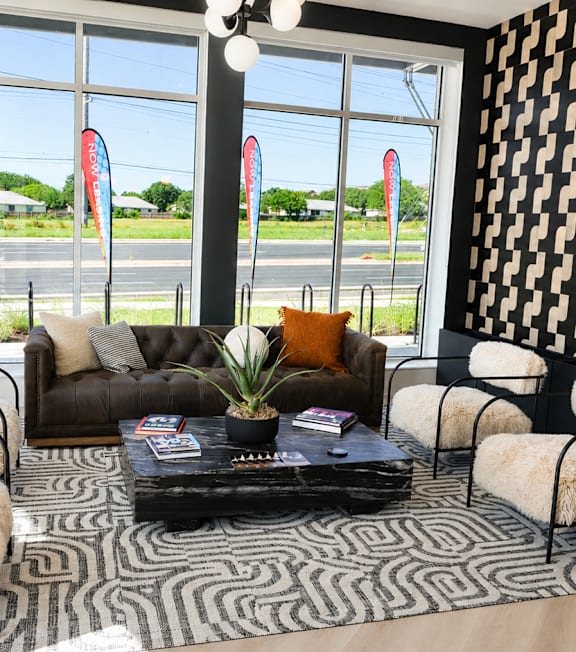 A black and white patterned wall in a room with a table and chairs. at Augustine, Austin, TX 78748