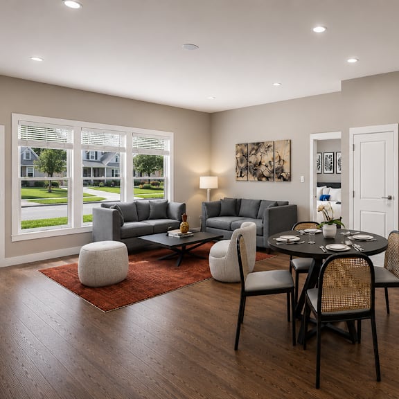A modern kitchen with a dining table and chairs in the middle.