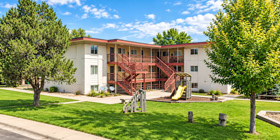 A white building with a red staircase in front of it.
