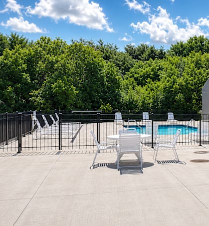 A large building with a pool in front of it.