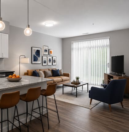 A modern kitchen with a large island and bar stools.