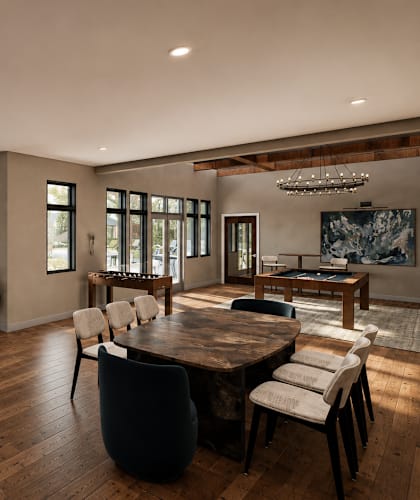 A modern living room with a large wooden table and chairs.