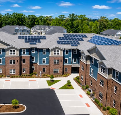 A large building with solar panels on the roof.