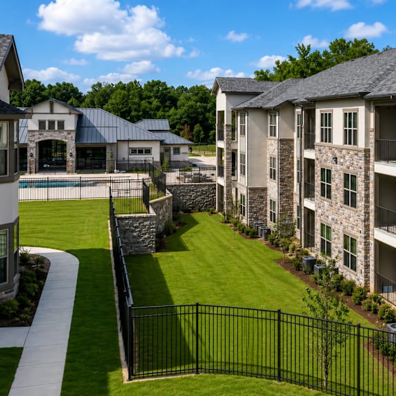 Auberge of Tyler apartment buildings overlooking landscaped lawns and mature trees.