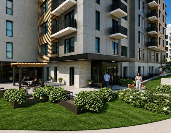 A modern building with a green lawn in front.