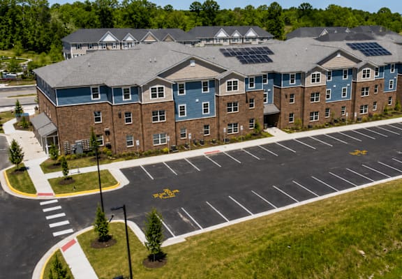 A large building with a parking lot in front of it.