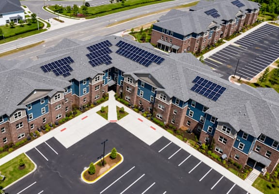 A large building with solar panels on the roof.