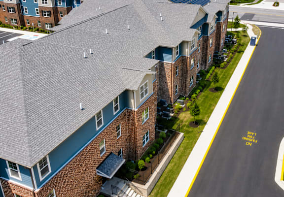 A street view of a residential area with apartment buildings.