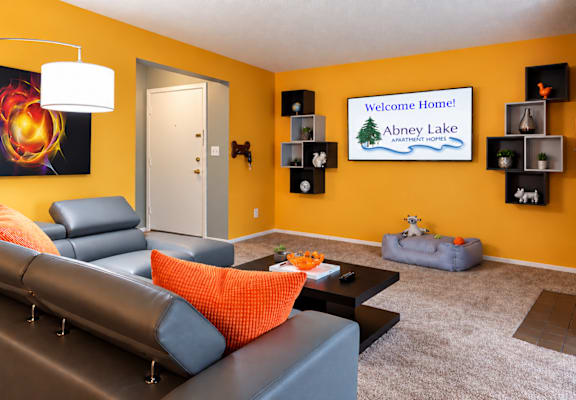 A living room with a fireplace and a painting on the wall.