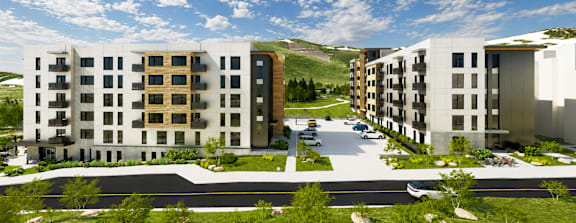 A modern apartment complex with a parking lot in front.