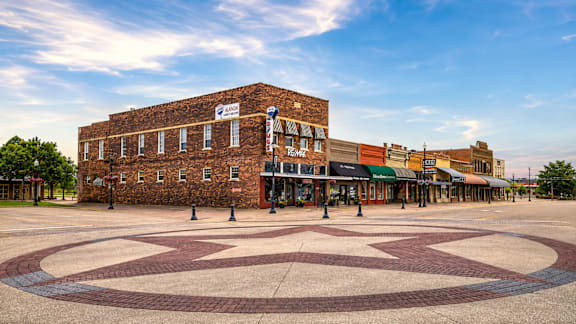 A large brick building with a sign that says "The Brick" in front of it.
