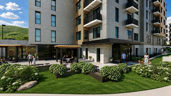 A modern building with a green lawn in front.