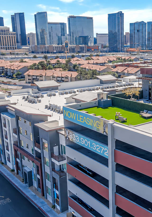 A view of a city from a high vantage point with a building in the foreground.