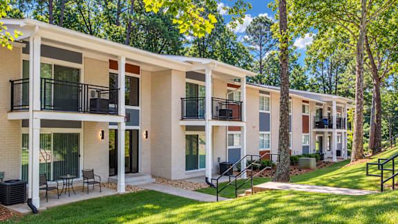 A row of modern townhouses with balconies and black railings.