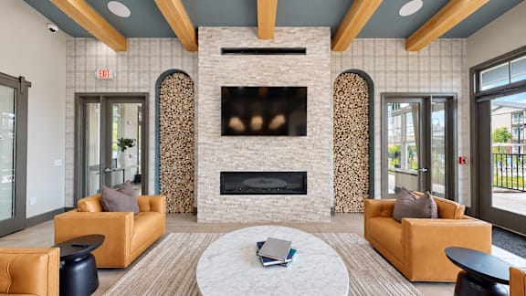 A modern living room with a fireplace and a coffee table.