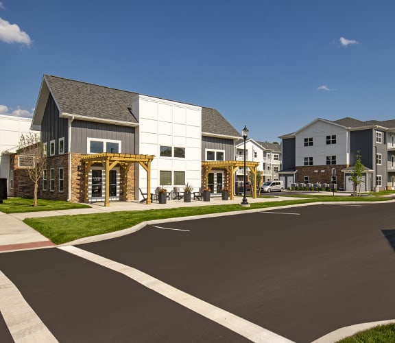 a view of an empty street with a row of apartment buildings