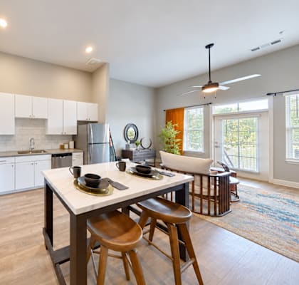 A modern kitchen with a dining table and chairs.