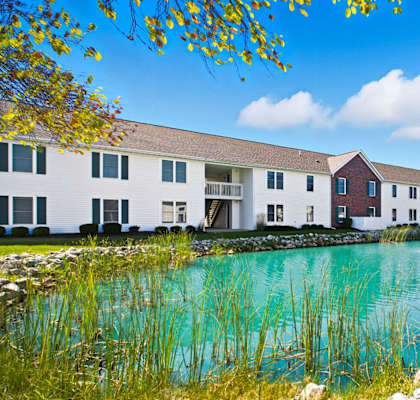 A row of houses with a body of water in front.