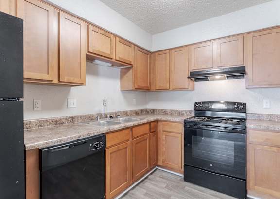 Pet-Friendly Apartments in Antioch, TN– Hickory Lake – A kitchen with black appliances and wooden cabinets.